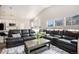 Spacious living room with vaulted ceilings, natural light, and views into the open kitchen area at 9434 Ashbury Cir # 204, Parker, CO 80134