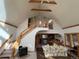 Open living room with vaulted ceilings and a cozy fireplace at 4924 S Indian Trl, Evergreen, CO 80439
