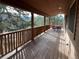 Covered porch with wooden railings and mountain views at 4924 S Indian Trl, Evergreen, CO 80439