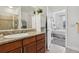 Bathroom with granite countertop, wooden cabinets, and a glimpse into an adjacent bedroom at 1700 N Emerson St # 305, Denver, CO 80218