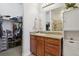 Bathroom with granite countertop vanity, storage cabinet, and walk-in closet at 1700 N Emerson St # 305, Denver, CO 80218