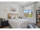 Bright bedroom with large window and a comfortable bed with attractive bamboo headboard at 1700 N Emerson St # 305, Denver, CO 80218