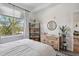 Airy bedroom with a window offering outdoor views, complemented by light-toned furniture at 1700 N Emerson St # 305, Denver, CO 80218