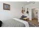 Bedroom featuring a keyboard, guitars, bed, and an ensuite bathroom for convenience at 1700 N Emerson St # 305, Denver, CO 80218