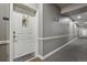 Clean and well-lit hallway with neutral colors and modern lighting fixtures at 1700 N Emerson St # 305, Denver, CO 80218