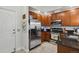 Functional kitchen showcasing stainless steel refrigerator, microwave, and gas range at 1700 N Emerson St # 305, Denver, CO 80218
