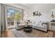 Bright living room with large sectional sofa, access to the balcony, and open floor plan at 1700 N Emerson St # 305, Denver, CO 80218