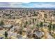 Picturesque aerial view of a residential neighborhood featuring tree-lined streets and varied home styles against a mountain backdrop at 3014 E Fremont Dr, Centennial, CO 80122