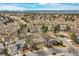 Sprawling aerial shot showcasing a tranquil residential community with lush trees and diverse home designs under a vast sky at 3014 E Fremont Dr, Centennial, CO 80122