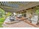 Inviting back patio with pergola, comfortable seating, and a tranquil water feature at 3014 E Fremont Dr, Centennial, CO 80122