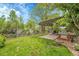 Lush backyard featuring a pergola-covered patio, landscaped with vibrant greenery and a well-maintained lawn at 3014 E Fremont Dr, Centennial, CO 80122