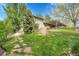 Charming backyard with a wooden fence, stone path, and pergola-covered patio, blending nature and comfort at 3014 E Fremont Dr, Centennial, CO 80122