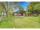Expansive backyard featuring a shaded pergola-covered patio, with comfortable seating and manicured lawn at 3014 E Fremont Dr, Centennial, CO 80122