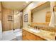 Bathroom features wood plank tile, shower-tub combo, and granite countertop at 3014 E Fremont Dr, Centennial, CO 80122