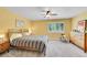 Cozy bedroom with yellow walls, large window, ceiling fan, and neutral carpet at 3014 E Fremont Dr, Centennial, CO 80122