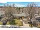 Charming ranch home with mature trees, a well-manicured lawn, and a two-car garage, blending curb appeal with comfort at 3014 E Fremont Dr, Centennial, CO 80122