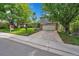 Well-kept home with a manicured lawn, a two-car garage, and a 'For Sale' sign in the front yard at 3014 E Fremont Dr, Centennial, CO 80122
