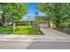 Well-maintained home featuring a lush front yard, a two-car garage, and a welcoming entryway at 3014 E Fremont Dr, Centennial, CO 80122
