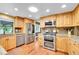 Kitchen features stainless steel appliances, wood cabinets, and granite countertops at 3014 E Fremont Dr, Centennial, CO 80122