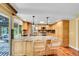 Bright kitchen with granite countertops, wood cabinets, and bar seating at 3014 E Fremont Dr, Centennial, CO 80122