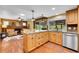 Well-equipped kitchen featuring wooden cabinets, stainless steel appliances, and a view of the outdoor area at 3014 E Fremont Dr, Centennial, CO 80122