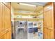 Functional laundry room featuring a modern washer, dryer, and ample storage shelves for supplies at 3014 E Fremont Dr, Centennial, CO 80122