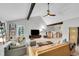 Bright living room with vaulted ceilings, exposed beams, comfortable seating and great natural light at 3014 E Fremont Dr, Centennial, CO 80122