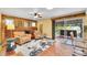 Cozy living room featuring a brick fireplace, comfortable armchairs, and access to an outdoor patio at 3014 E Fremont Dr, Centennial, CO 80122