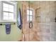 Shower with stone tile, glass door, and built-in seat at 3014 E Fremont Dr, Centennial, CO 80122