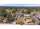 Neighborhood aerial view of the home, featuring a fenced yard, a storage building, and mountain views at 1742 S Alcott St, Denver, CO 80219
