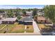 Charming home with solar panels, a long driveway, a fenced yard, and inviting curb appeal at 1742 S Alcott St, Denver, CO 80219