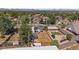 Aerial shot showcases the property with solar panels, fenced backyard, a storage building, and surrounding neighborhood at 1742 S Alcott St, Denver, CO 80219