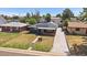 Aerial view of a charming single story home, showcasing the roof's solar panels and long driveway at 1742 S Alcott St, Denver, CO 80219