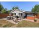 Charming backyard featuring a dining area, BBQ grill, and relaxing hot tub at 1742 S Alcott St, Denver, CO 80219