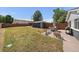 Fenced backyard with patio area, shed, table, chairs, grill, and ample space for outdoor enjoyment at 1742 S Alcott St, Denver, CO 80219