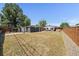 Large fenced backyard featuring a storage shed, patio with outdoor seating, and lush greenery at 1742 S Alcott St, Denver, CO 80219