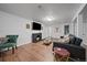 Finished basement features a fireplace, tv, and wood-look flooring at 1742 S Alcott St, Denver, CO 80219