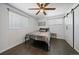 Cozy bedroom with dark wood floors, ceiling fan, and neutral decor at 1742 S Alcott St, Denver, CO 80219