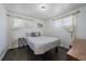 Bright bedroom featuring neutral decor, wood floors, and sheer window treatments at 1742 S Alcott St, Denver, CO 80219