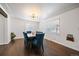 Dining room featuring dark hardwood floors, large windows and seating for six at 1742 S Alcott St, Denver, CO 80219