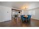 Bright dining room open to the kitchen, featuring modern lighting and hardwood floors at 1742 S Alcott St, Denver, CO 80219