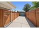 Long driveway leading to the detached garage, surrounded by a privacy fence and a serene outdoor space at 1742 S Alcott St, Denver, CO 80219
