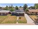 Inviting home exterior with solar panels, well-maintained lawn, walkway, and a long driveway at 1742 S Alcott St, Denver, CO 80219