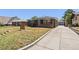 Charming single-story home with inviting front porch, solar panels, and a long driveway to the garage at 1742 S Alcott St, Denver, CO 80219
