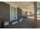 Inviting front porch featuring a stylish door, modern planters, and covered seating area at 1742 S Alcott St, Denver, CO 80219