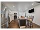 Modern kitchen featuring stainless steel appliances, central island and barstool seating at 1742 S Alcott St, Denver, CO 80219