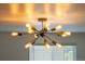 Modern starburst lighting fixture in the dining room with natural light shining through the window at 1742 S Alcott St, Denver, CO 80219