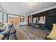 Bright living room featuring a fireplace, sliding glass doors, and gray flooring at 1742 S Alcott St, Denver, CO 80219