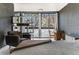 Bedroom showcasing natural light with a cozy armchair and decorative wall shelving at 1050 N Corona St # 206, Denver, CO 80218