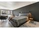 Well-lit bedroom with modern furnishings and elegant, dark accent wall at 1050 N Corona St # 206, Denver, CO 80218